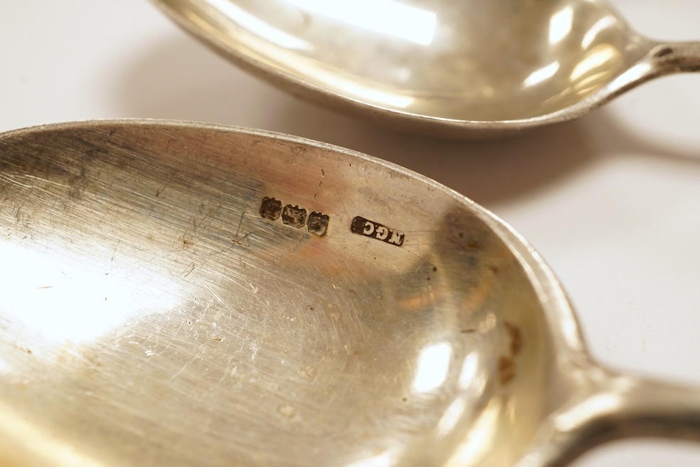 A matched set of six mainly George V silver/white metal and enamel teaspoons, with terminals decorated with dog's heads, 13.6cm. Condition - fair